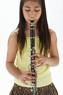 School girl playing the clarinet