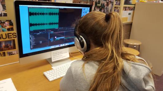 girl wearing headphones at computer 