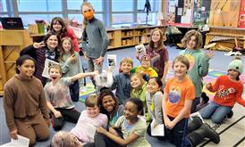 Choir students  gathered on classroom floor