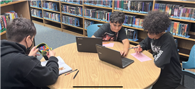 three students working on flipgrid in the library